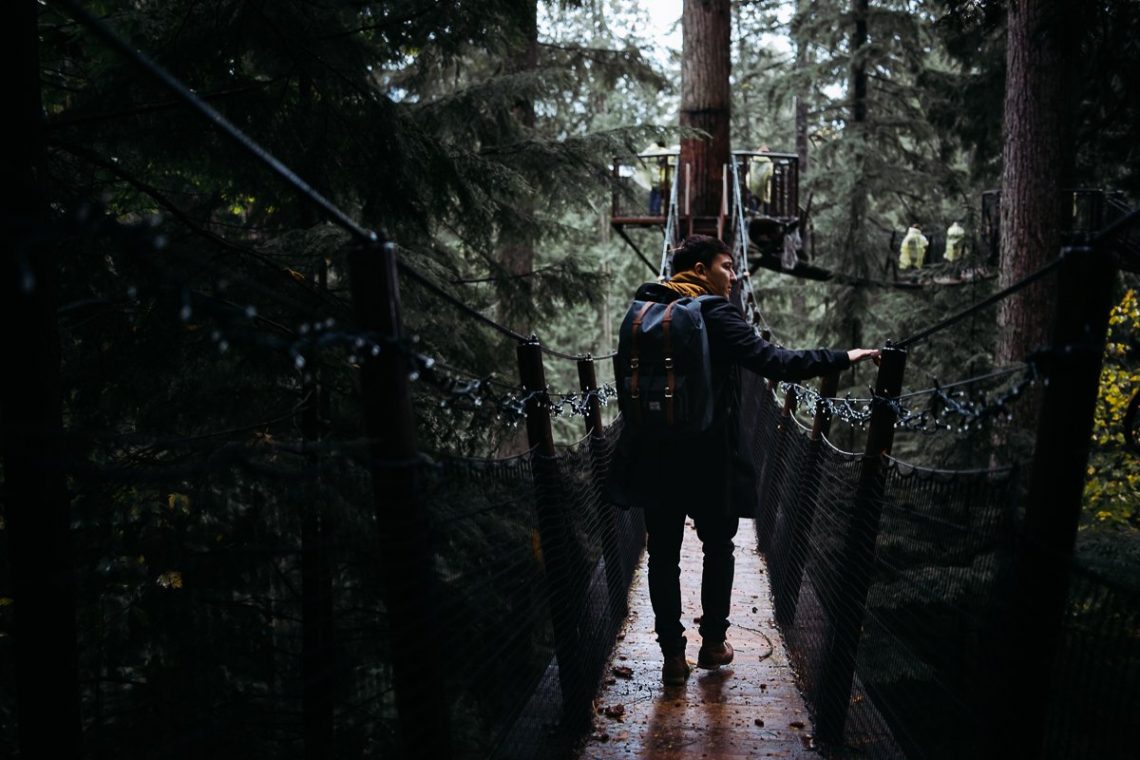 Capilano Suspension Bridge Park Trees Forest Backpack Man in Coat